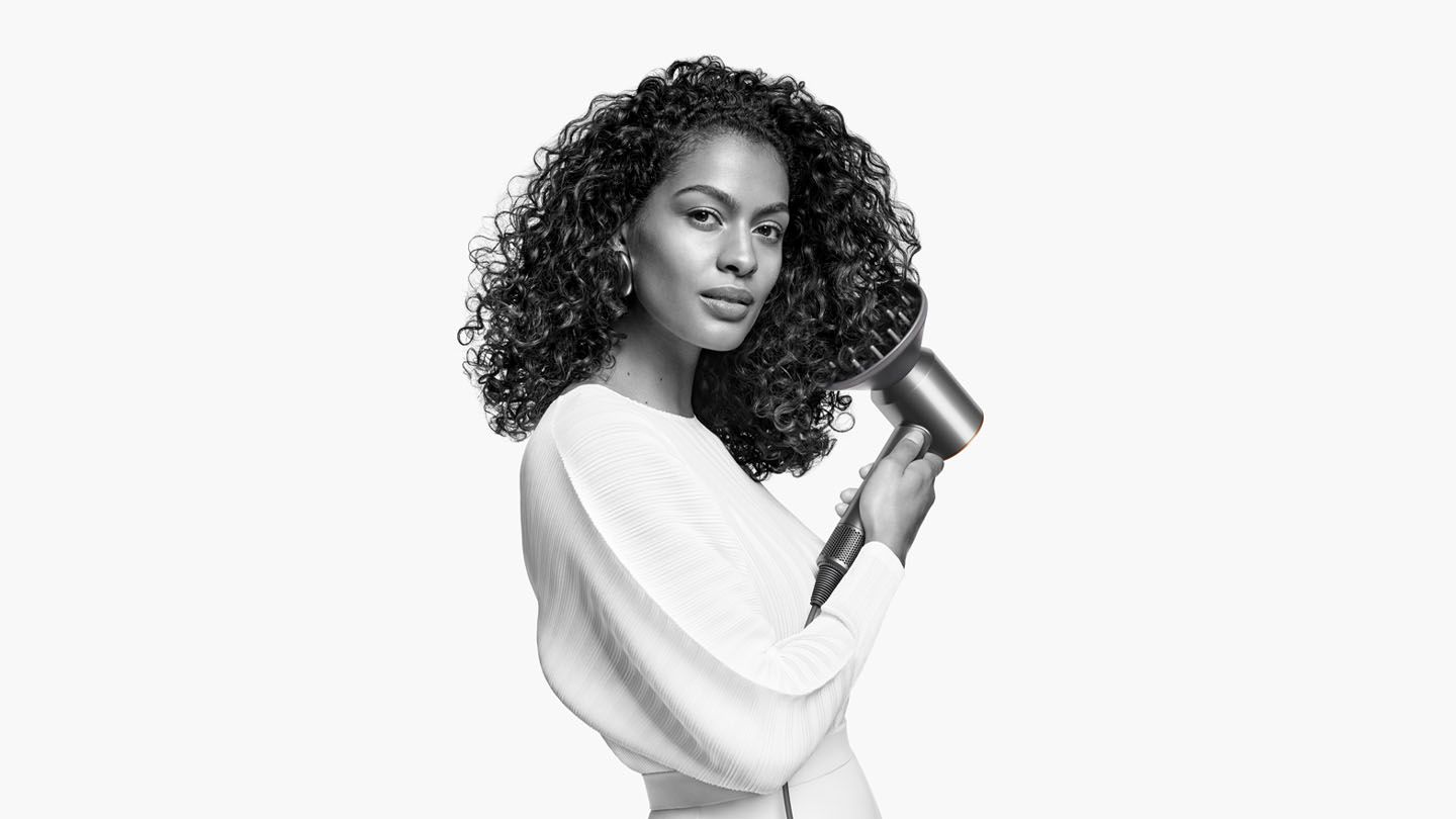 Model using Dyson Supersonic™ hair dryer 
